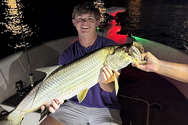 Hayes holding his first tarpon caught on a Fort Lauderdale fishing charter with Captain Jeff Maggio.